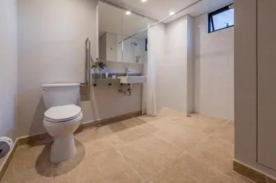 a bathroom with a toilet and a sink at El Tesoro Medellín Hab309 by Letoh in Medellín