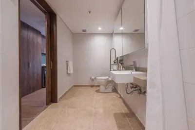 a bathroom with a toilet and a sink and a mirror at El Tesoro Medellín Hab311 by Letoh in Medellín