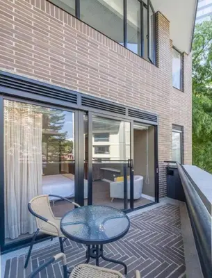 a patio with a glass table and chairs and a bedroom at El Tesoro Medellín Hab311 by Letoh in Medellín