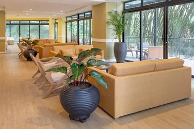a lobby with a couch and a table and chairs at El Tesoro Medellín Hab311 by Letoh in Medellín