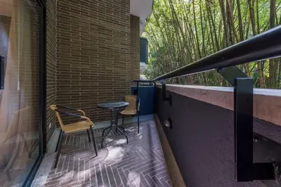 a balcony with two chairs and a table on it at El Tesoro Medellín Hab314 by Letoh in Medellín