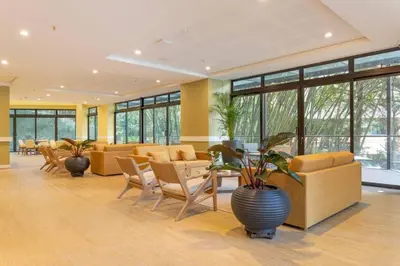 a lobby with couches and a table and chairs at El Tesoro Medellín Hab314 by Letoh in Medellín