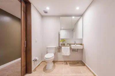 a bathroom with a toilet and a sink at El Tesoro Medellín Hab315 by Letoh in Medellín