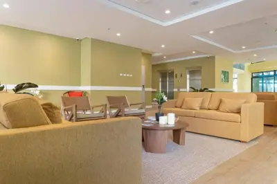 a living room with two couches and a table at El Tesoro Medellín Hab315 by Letoh in Medellín