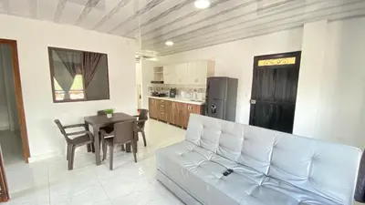 a living room with a white couch and a table at Apartamento Balcón 302 in San Luis