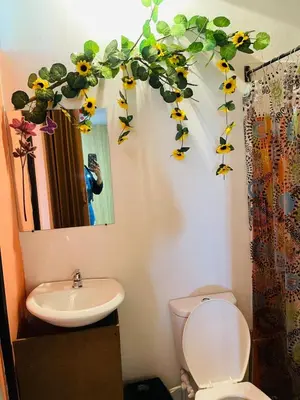 a bathroom with a sink and a toilet and a mirror at EL EDEN HABITACIONES in Manizales