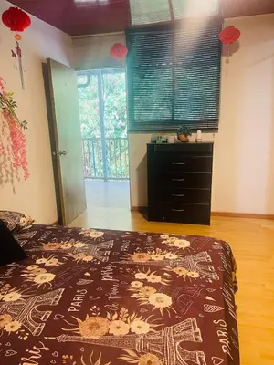 a bedroom with a bed and a dresser and a window at EL EDEN HABITACIONES in Manizales