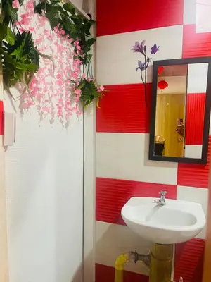 a bathroom with a sink and red and white stripes at EL EDEN HABITACIONES in Manizales