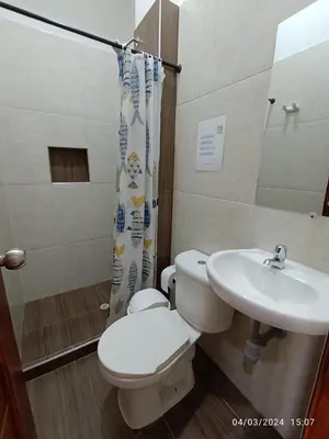 a bathroom with a toilet and a sink at La ceiba casa campestre in Sonsón
