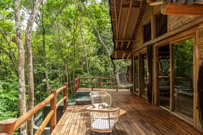 a porch of a cabin with a table and chairs at Hotel Boutique Maitta en Doradal Antioquia in Doradal