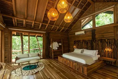 a bedroom with a bed in a wooden cabin at Hotel Boutique Maitta en Doradal Antioquia in Doradal