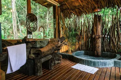 a bathroom in a tree house with a wooden floor at Hotel Boutique Maitta en Doradal Antioquia in Doradal