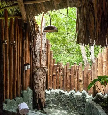 a building with a wooden fence and a light at Hotel Boutique Maitta en Doradal Antioquia in Doradal