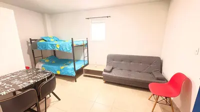 a room with a bed and a couch and a chair at Apartaestudio sector la presentacion in Manizales