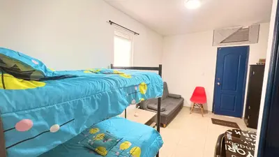 a bedroom with a bed with a blue comforter at Apartaestudio sector la presentacion in Manizales