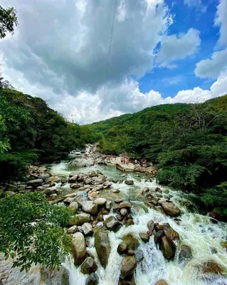 a river with rocks and people in the water at Apartamento Balcón 201 in San Luis