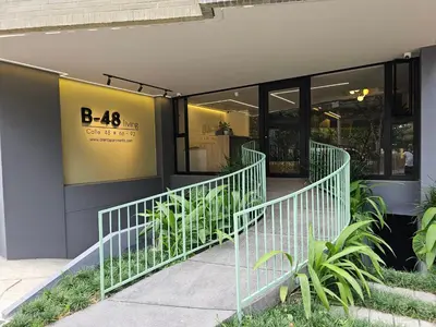 a store front with plants outside of a building at B 48 Living by B Rent in Medellín