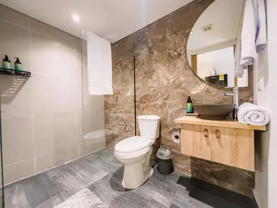 a bathroom with a toilet and a sink and a mirror at B 48 Living by B Rent in Medellín