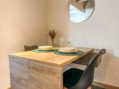 a dining room table with two chairs and a mirror at B 48 Living by B Rent in Medellín
