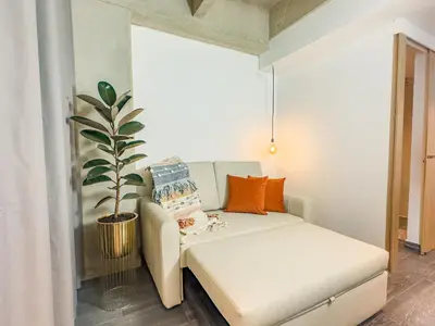 a small room with a couch and a plant at B 48 Living by B Rent in Medellín