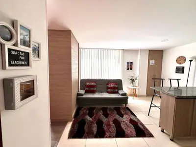 a living room with a couch and a fireplace at Confortable apartaestudio in Manizales