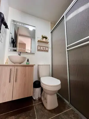 a bathroom with a toilet and a sink at Confortable apartaestudio in Manizales