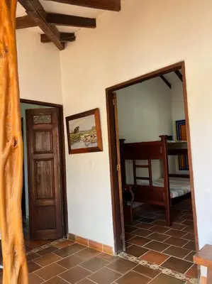 a room with a door and a mirror and a bedroom at Finca Sierra Luz in Jericó