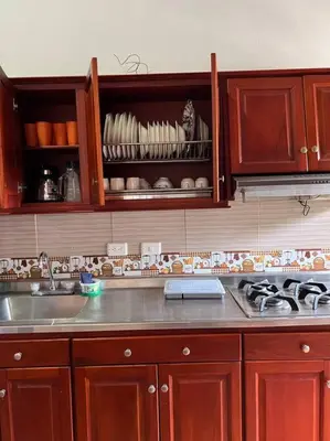 a kitchen with wooden cabinets and a kitchen sink at Finca Sierra Luz in Jericó
