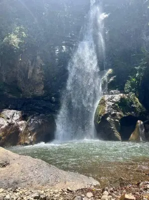a waterfall in the middle of a river at Finca Sierra Luz in Jericó