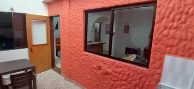 a red wall with a mirror in a room at Apartamento Rionegro cerca a Aeropuerto in Rionegro