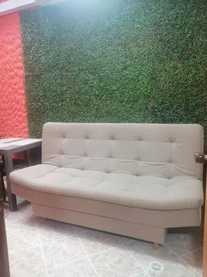 a white couch in front of a green wall at Apartamento Rionegro cerca a Aeropuerto in Rionegro