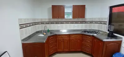 a kitchen with wooden cabinets and a sink at Apartamento Rionegro cerca a Aeropuerto in Rionegro