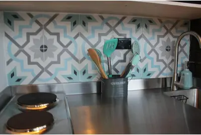 a cup of utensils on a stove in a kitchen at Cabaña con jacuzzi y acceso al embalse - Portum II in El Peñol