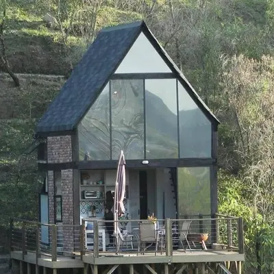 a small house with glass windows on a deck at Cabaña con jacuzzi y acceso al embalse - Portum I in El Peñol