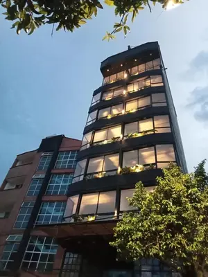 a tall building with lights in the windows at perla 3 dormitorios in Bello