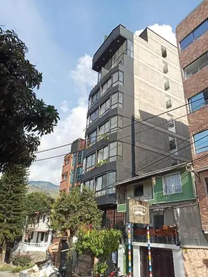 a tall building on the side of a street at perla 3 dormitorios in Bello