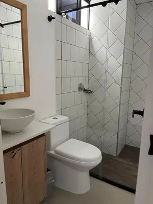 a bathroom with a toilet and a sink and a shower at perla 3 dormitorios in Bello