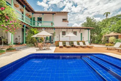 a villa with a swimming pool and a house at Casa Cedrela Hotel Boutique -Cauca Viejo- Mayores de 14 años in Jericó