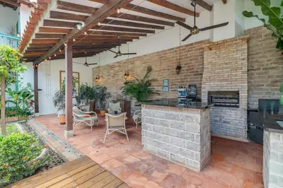 an outdoor kitchen and dining area with a brick wall at Casa Cedrela Hotel Boutique -Cauca Viejo- Mayores de 14 años in Jericó