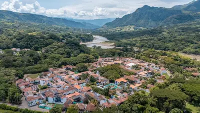 an aerial view of a village with a river and mountains at Casa Cedrela Hotel Boutique -Cauca Viejo- Mayores de 14 años in Jericó