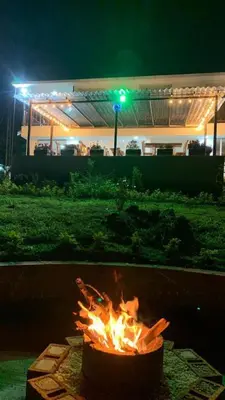 a fire pit in front of a building at night at AZAHARES HOTEL Y CAFÉ in Manizales