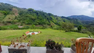 a view of a field with a view of a mountain at AZAHARES HOTEL Y CAFÉ in Manizales