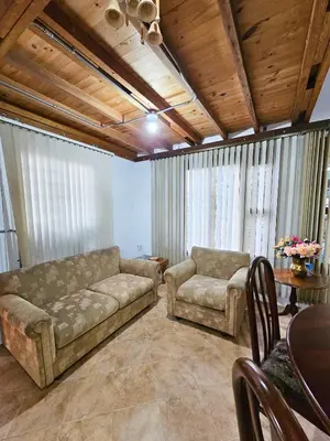 a living room with a couch and a table at Mirador del Lago, Rural House with ideal location in Marinilla
