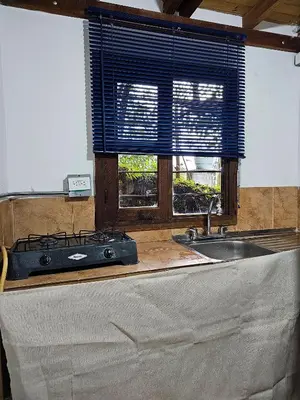 a kitchen with a stove and a sink and a window at Mirador del Lago, Rural House with ideal location in Marinilla