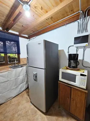 a kitchen with a stainless steel refrigerator and a microwave at Mirador del Lago, Rural House with ideal location in Marinilla