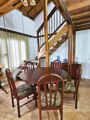 a dining room with a wooden table and chairs at Mirador del Lago, Rural House with ideal location in Marinilla