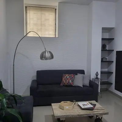 a living room with a blue couch and a table at LA CASA DEL CABLE - Hermoso Apartamento - in Manizales
