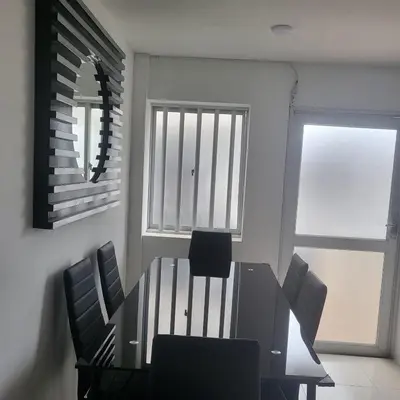 a dining room with a table and chairs and a mirror at LA CASA DEL CABLE - Hermoso Apartamento - in Manizales
