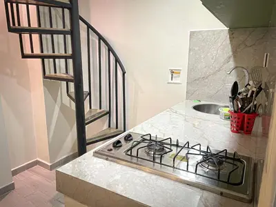 a kitchen with a stove and a sink at Loft Urbano la 70 Laurles estadio in Medellín