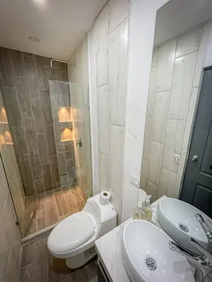 a bathroom with a toilet and a sink and a shower at Loft Urbano la 70 Laurles estadio in Medellín